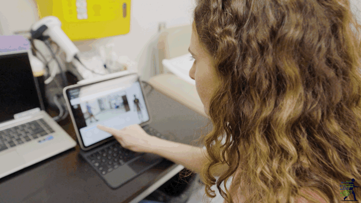 Movealytics review and scoring demo showing a clinician reviewing pose overlay and scoring output on a tablet.